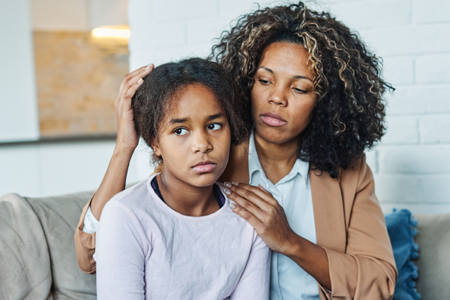 mother consoling daughter